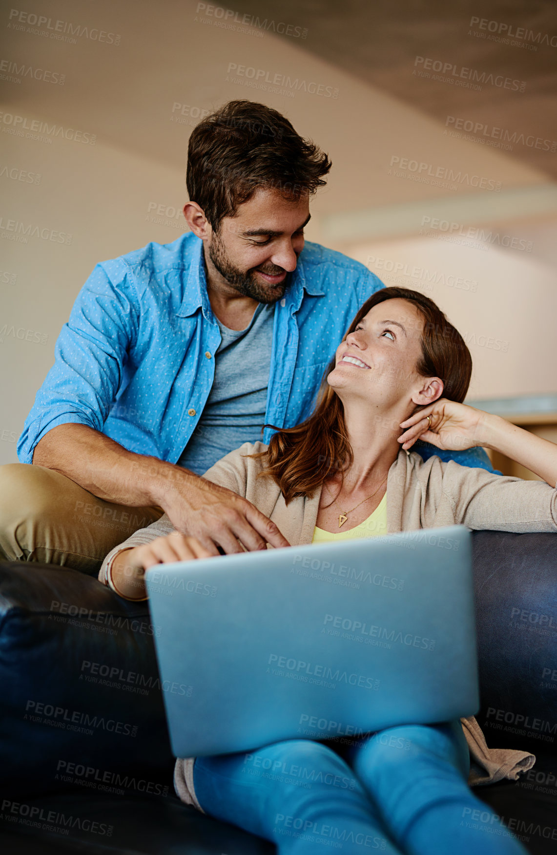 Buy stock photo Cropped shot of an affectionate young couple relaxing on the sofa at home