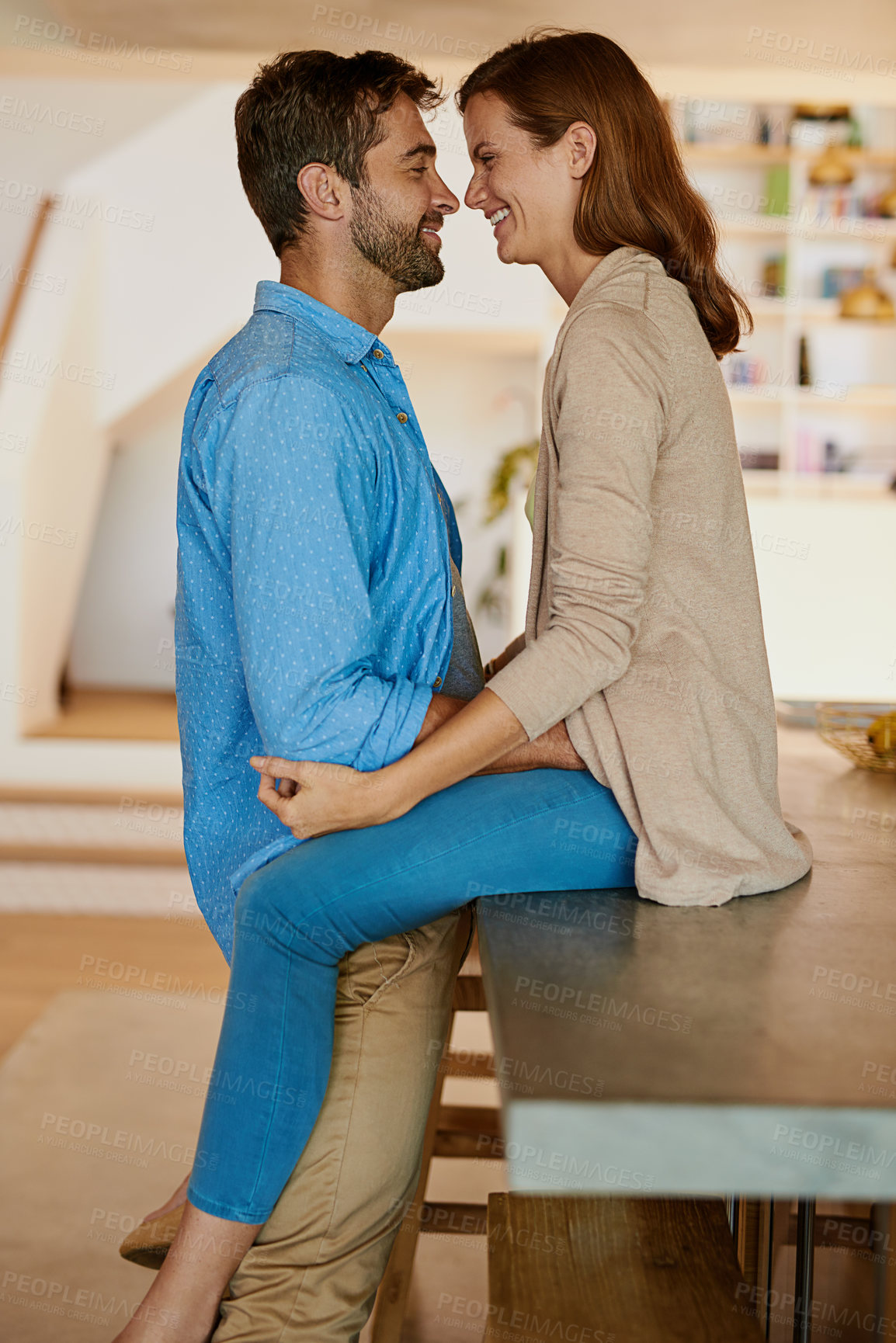 Buy stock photo Cropped shot of an affectionate young couple face to face in their kitchen