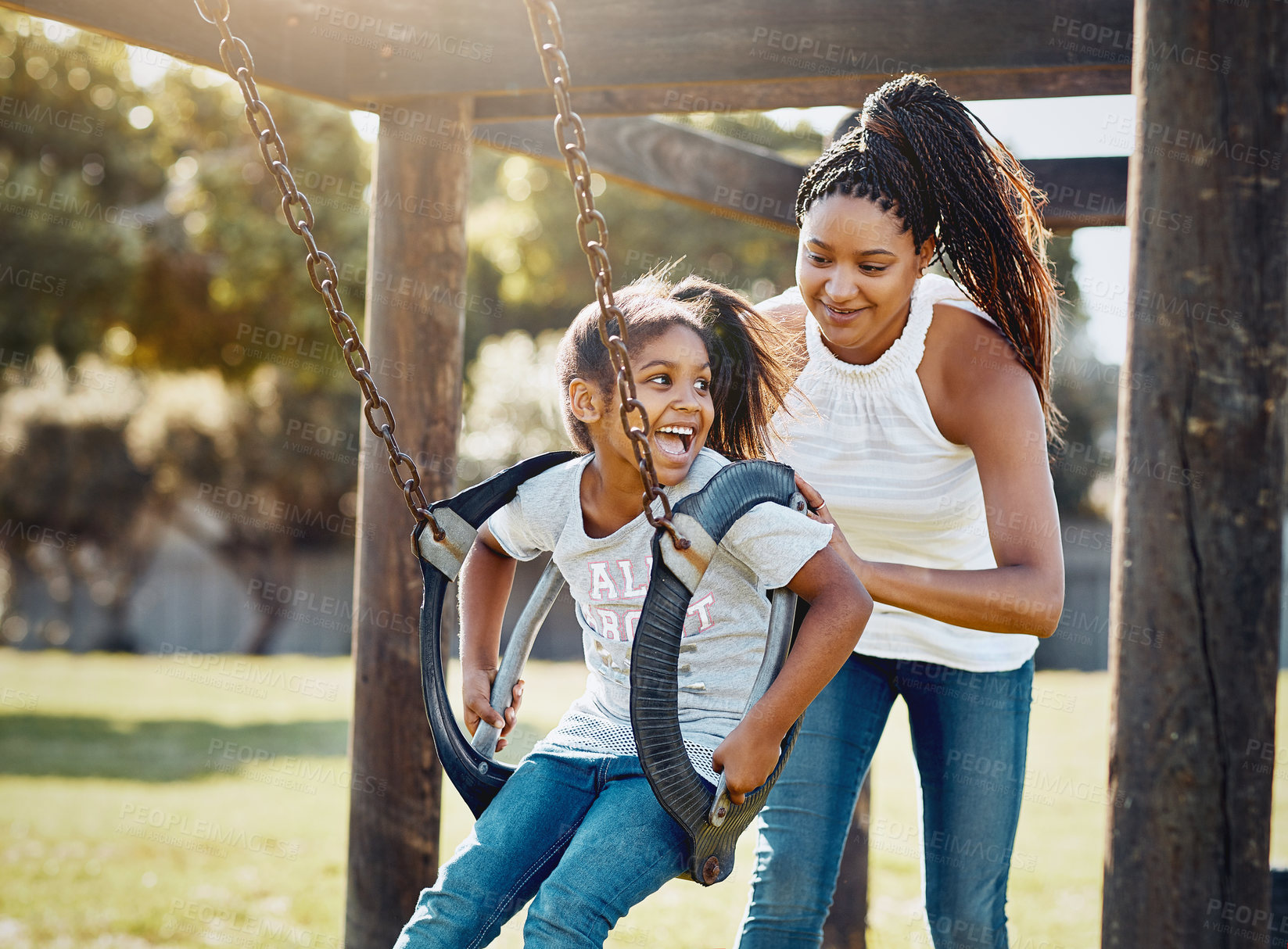 Buy stock photo Mother, happy and girl on swing at park for bonding, relationship and fun activity together with laugh. Family, smile and push child outdoor by playground for playing, games and development with tire