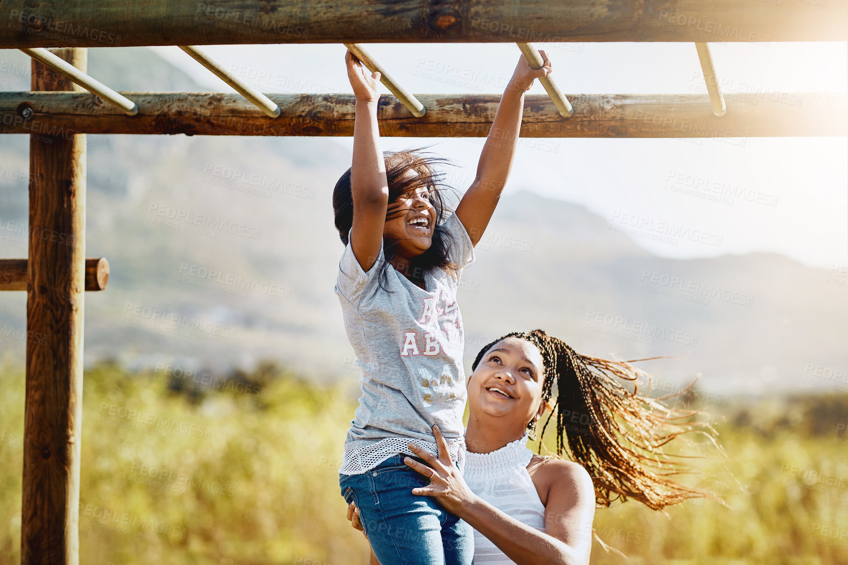 Buy stock photo Mother, happy child and play at jungle gym for support, energy or exercise with family at park. African mom, girl and kid at playground or climbing on monkey bar for health, help or laugh with parent