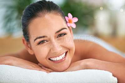 Buy stock photo Portrait of an attractive young woman relaxing on a massage table at a spa