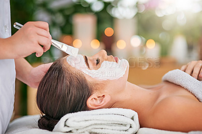 Buy stock photo Cropped shot of an attractive young woman getting a facial treatment at a spa
