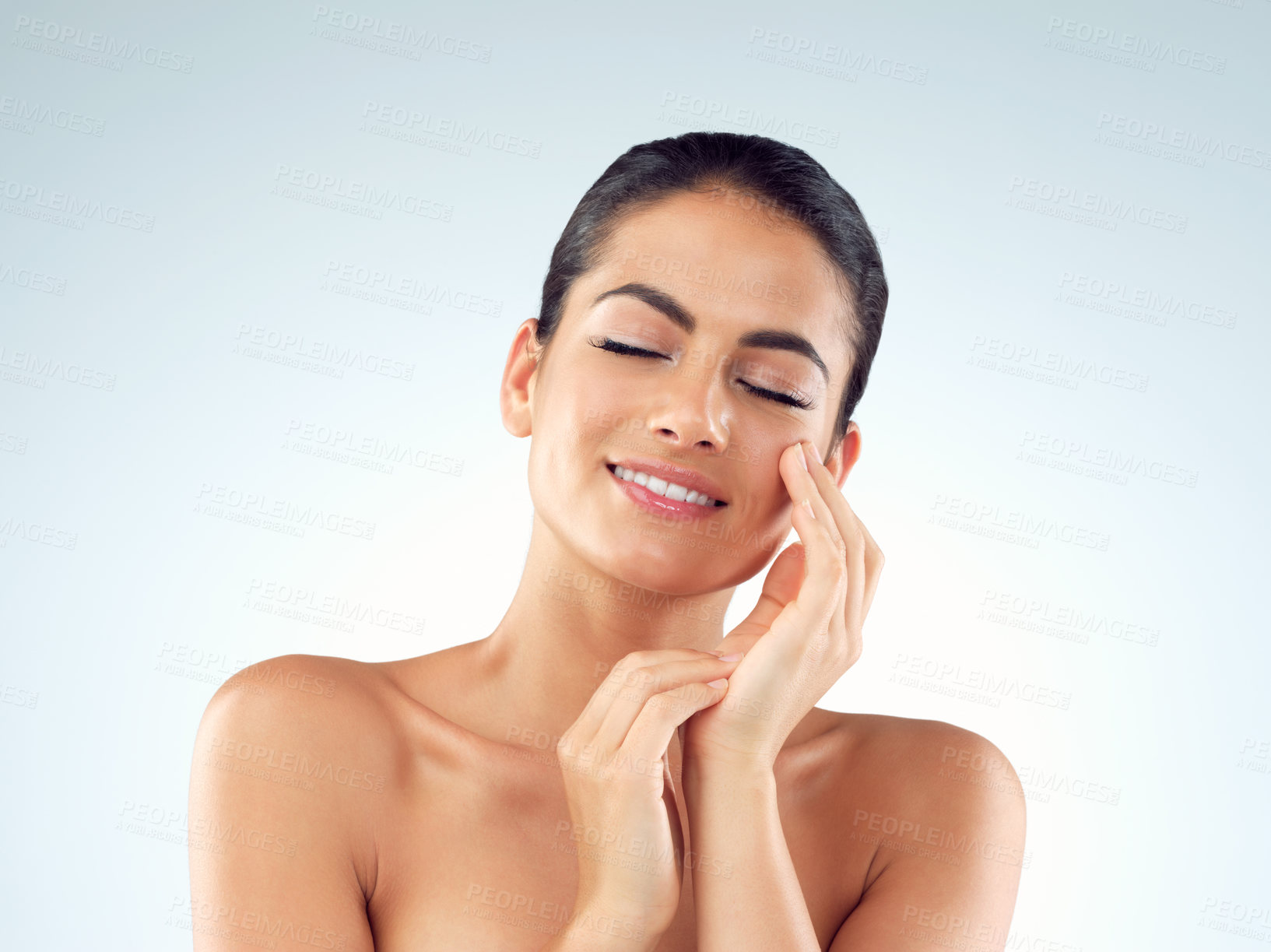 Buy stock photo Studio shot of an beautiful young woman feeling her skin against a gray background