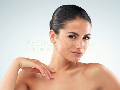 Buy stock photo Studio shot of an beautiful young woman feeling her skin against a gray background