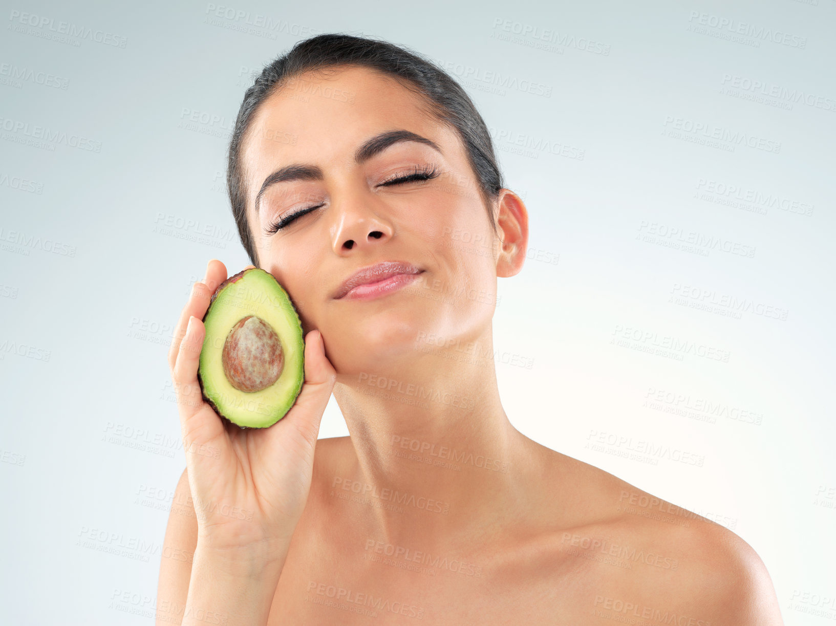 Buy stock photo Skincare, avocado and woman in studio with natural, beauty and organic facial treatment for glow. Health, face and person with dermatology with green fruit for collagen boost by white background.