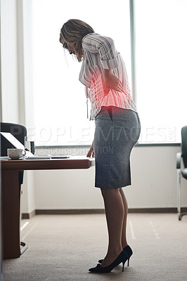 Buy stock photo Shot of a businesswoman suffering with back pain while working in an office
