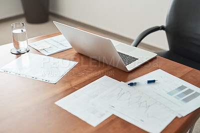 Buy stock photo Cropped shot of paperwork and a laptop on a desk in an office
