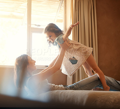 Buy stock photo Mom, girl and lift with plane on bed, happy and bonding with flight, love and playful in family home. Games, mother and daughter with laugh, excited or connection in morning at apartment in Australia