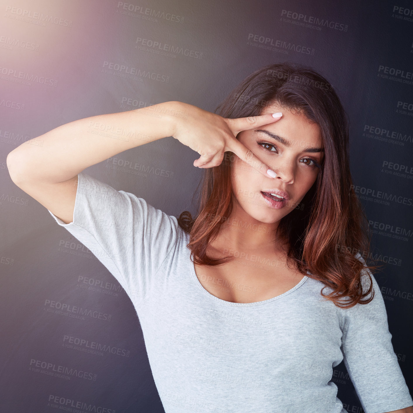 Buy stock photo Studio, portrait and woman with peace sign, cool attitude and hand gesture on face for expression. Female person, confident girl model and student in Italy with casual gen z with dark background