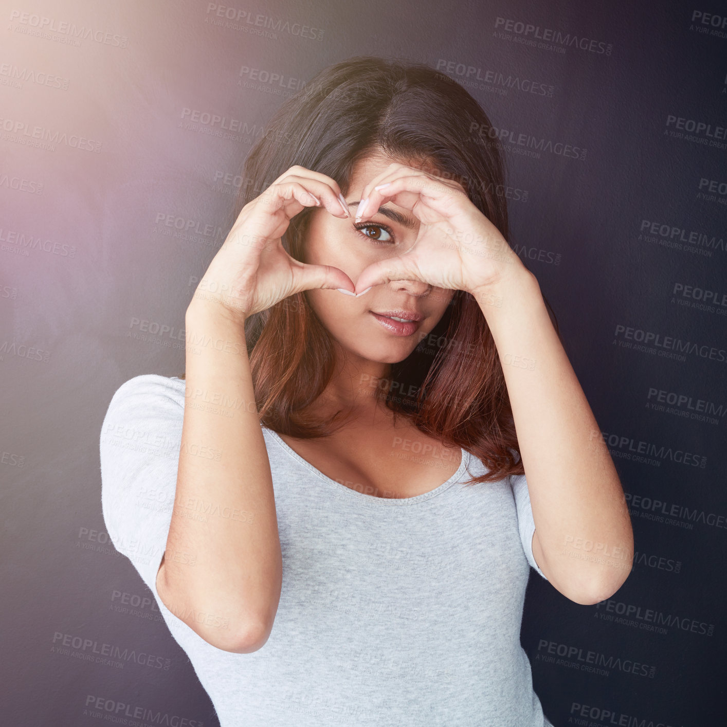 Buy stock photo Woman, eye and heart hands in studio for love, emoji and symbol of romance or support on backdrop. Female person, care and icon for peace or kindness, like and feedback or thank you and portrait 