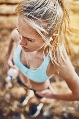 Buy stock photo Shot of a young woman listening to music before her workout