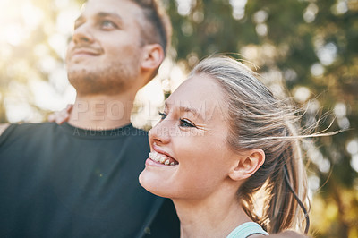 Buy stock photo Shot of a young couple smiling together outdoors