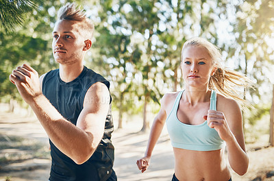Buy stock photo Shot of a young couple running together outside