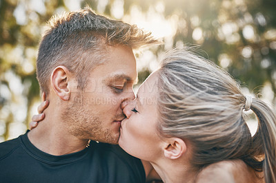 Buy stock photo Shot of a young couple kissing outdoors