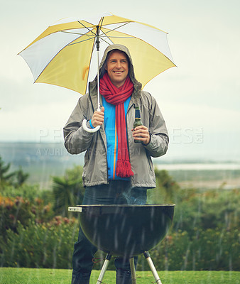 Buy stock photo Happy man, umbrella and barbecue in rain with beer for meal, supper or dinner on the fire grill. Male person smiling for insurance, cover or protection while cooking under raining or stormy weather