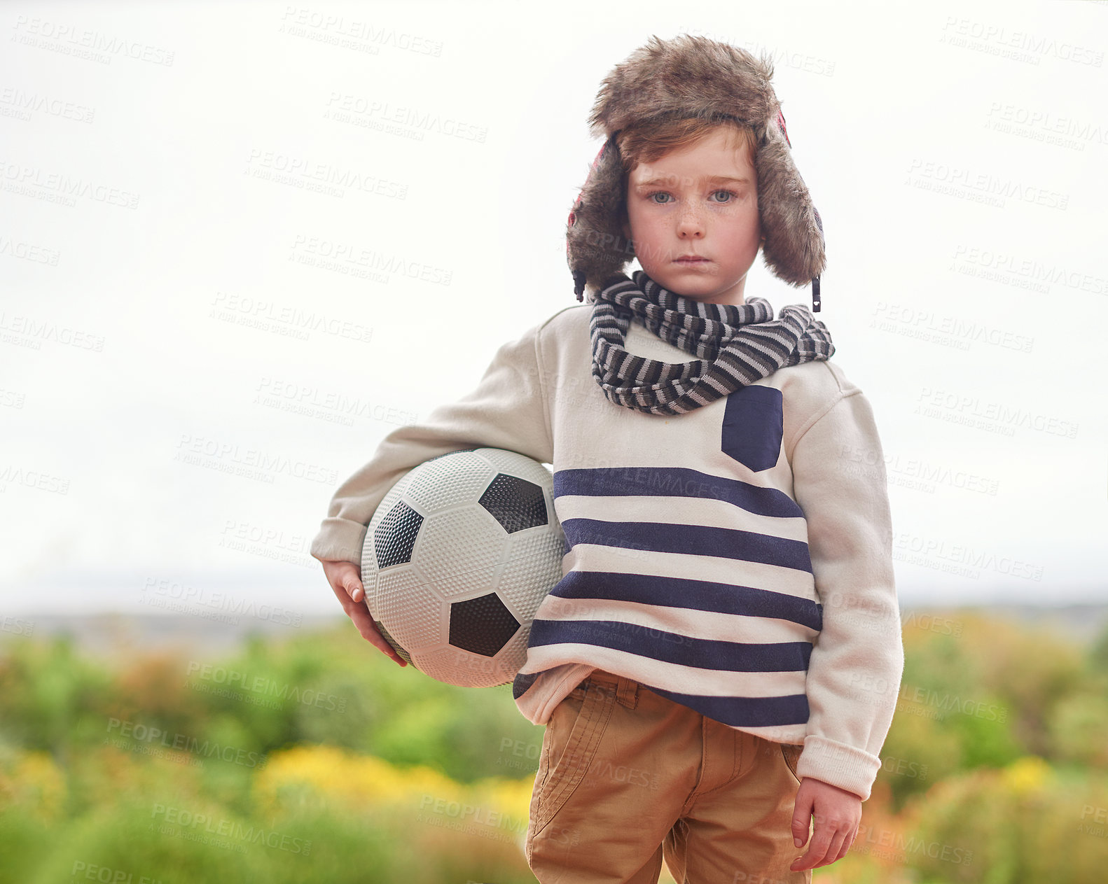 Buy stock photo Winter, portrait and kid with soccer ball outdoor ready for playing, sports or exercise and fitness. Young boy, lonely or bored in cold weather with beanie and scarf in England for football practice