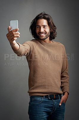 Buy stock photo Selfie, smartphone and man with memory in studio for profile picture, social media update or smile on dark background. Photography, mobile and male person for happiness, blog post or communication