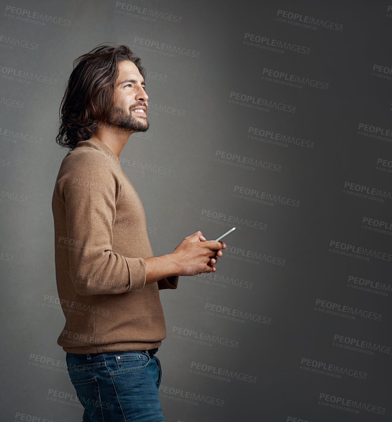 Buy stock photo Thinking, man and cellphone in studio for online, notification and mobile app for memory. Smile, male model and social media or internet for networking, communication and idea by dark background