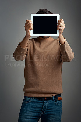Buy stock photo Tablet screen, mockup and man covering face in studio isolated on a gray background. Touchscreen, hiding and male person with space for marketing, advertising and technology for commercial promotion.