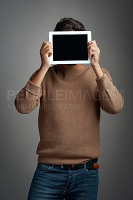 Buy stock photo Tablet screen, space and man covering face in studio isolated on a gray background. Touchscreen, hiding and male person with mockup for marketing, advertising and technology for commercial promotion.