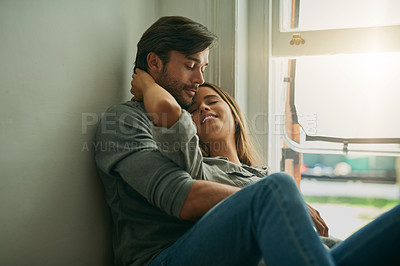 Buy stock photo Shot of an affectionate young couple embracing each other