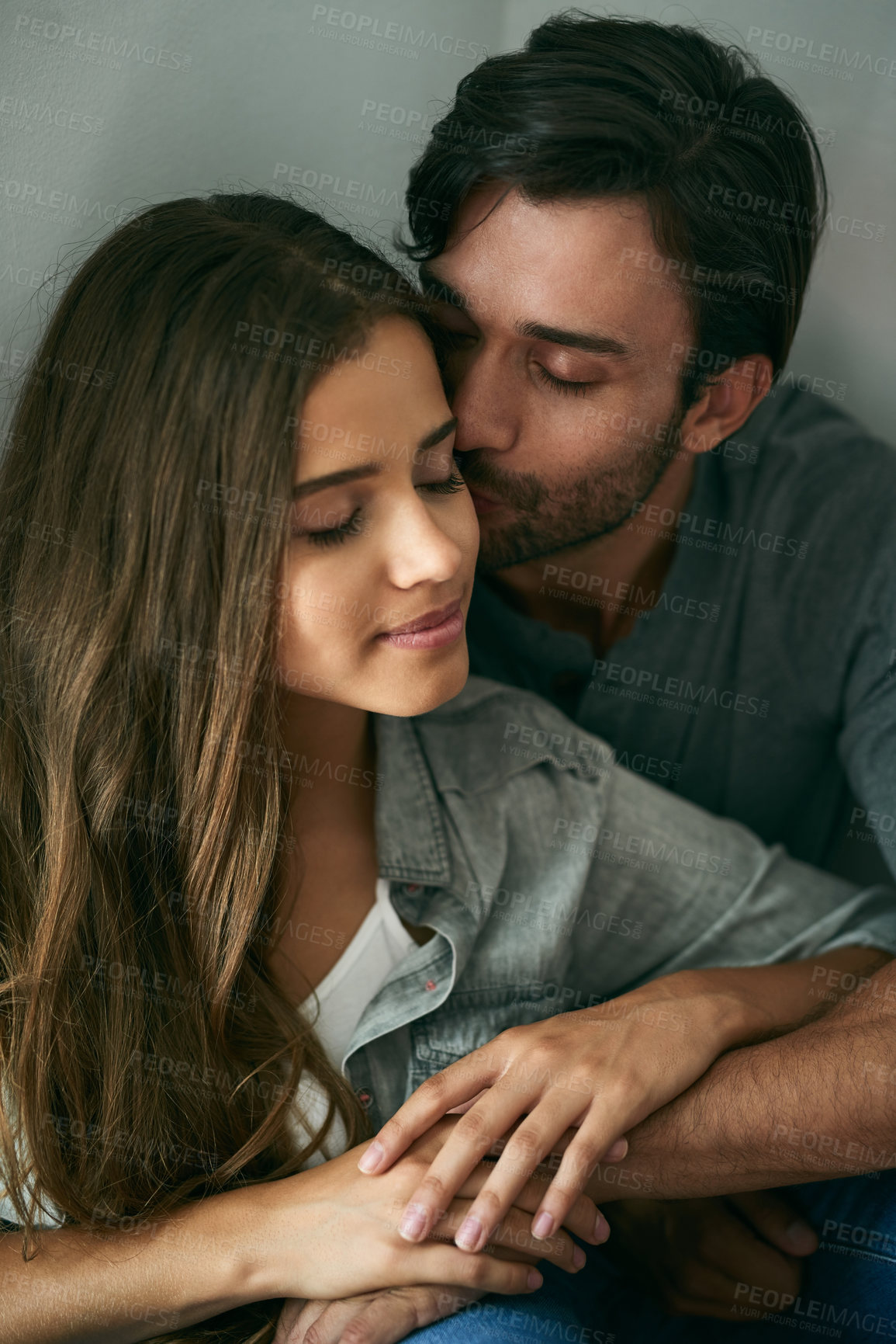 Buy stock photo Love, hug and couple kiss in home for care, connection or bonding together in healthy relationship. Man, woman and touch for romance, intimacy and holding hands to celebrate anniversary at apartment