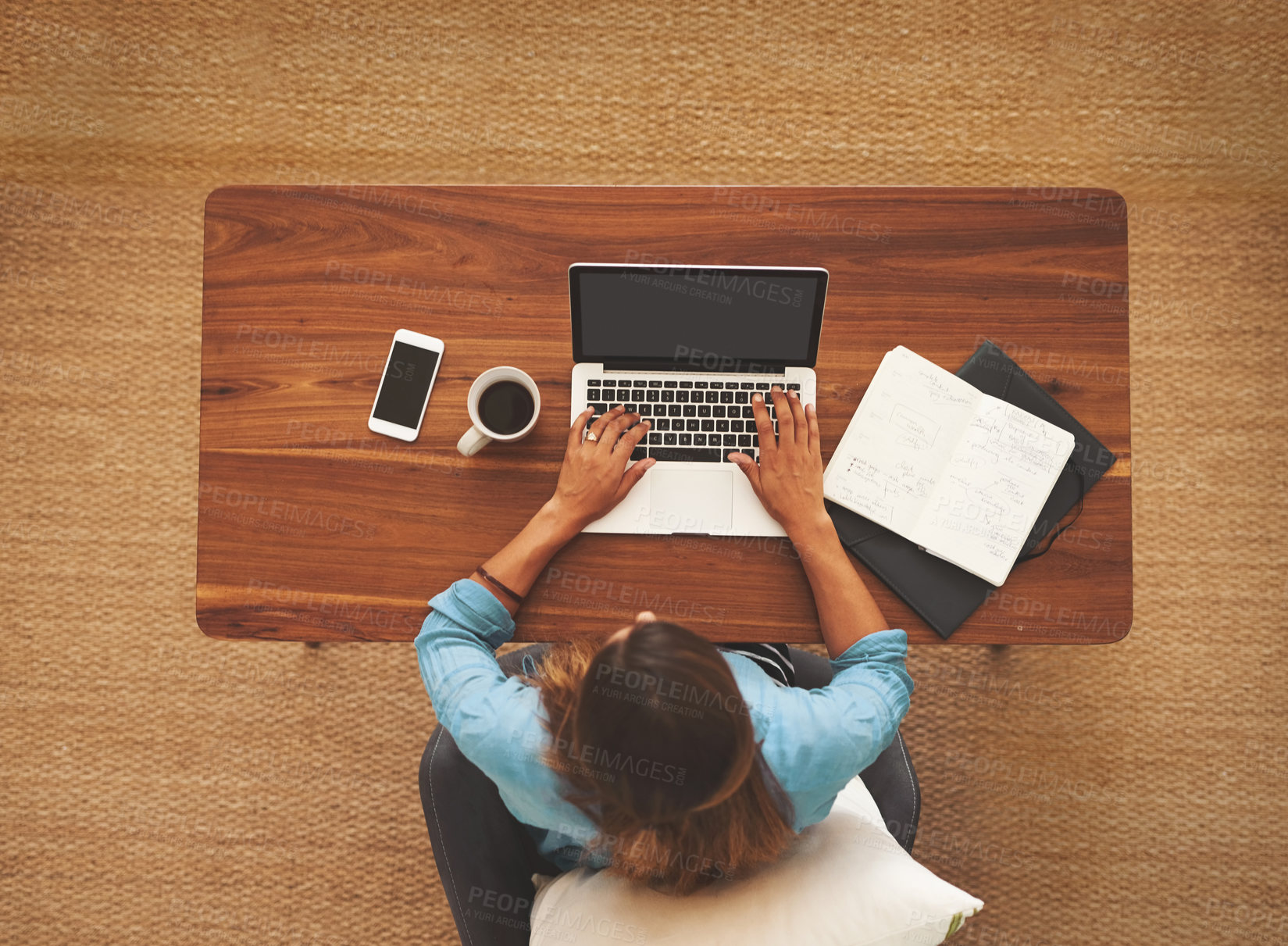 Buy stock photo High angle shot of an unidentifiable freelancer working from her desk at home