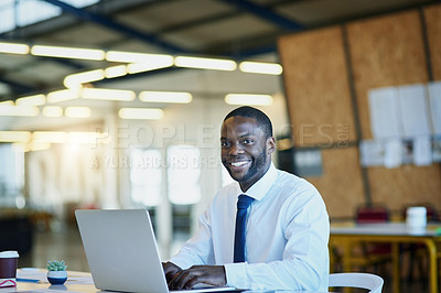 Buy stock photo Portrait of a businessman working on a laptop in an office