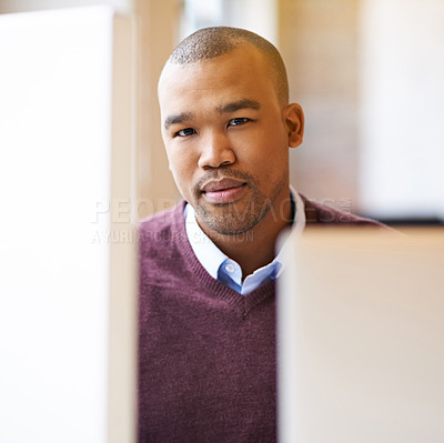 Buy stock photo Cropped shot of a handsome young designer working on his pc in the office and looking determined