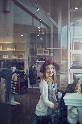 Buy stock photo Shot of a young woman shopping at a clothing store