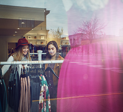 Buy stock photo Shot of two best friends out shopping in a clothing store