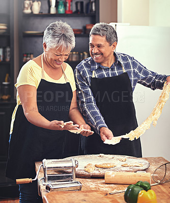 Buy stock photo Cooking, laugh and senior couple in kitchen at home with dough, flour and ingredients for meal. Happy, food and elderly man and woman preparing dinner, lunch or supper together at house in Mexico.