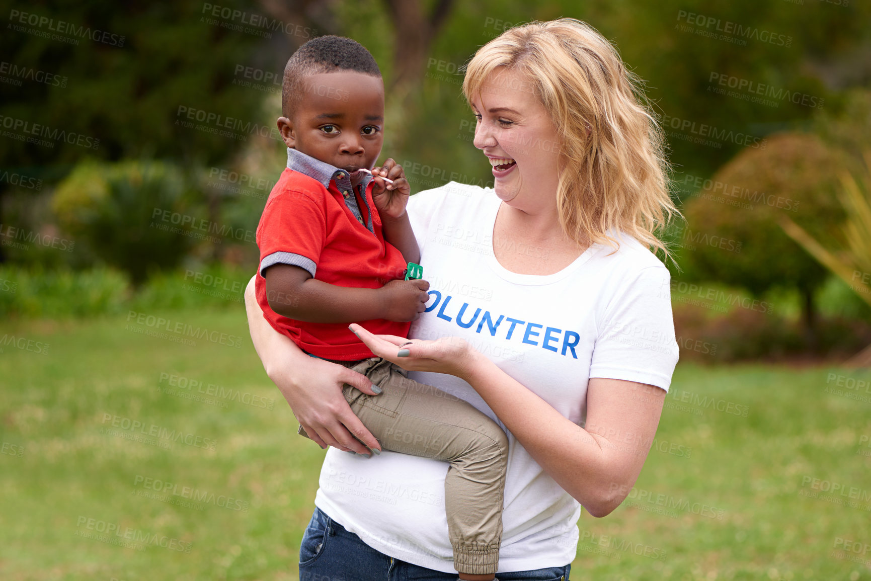 Buy stock photo Shot of volunteers working with little children