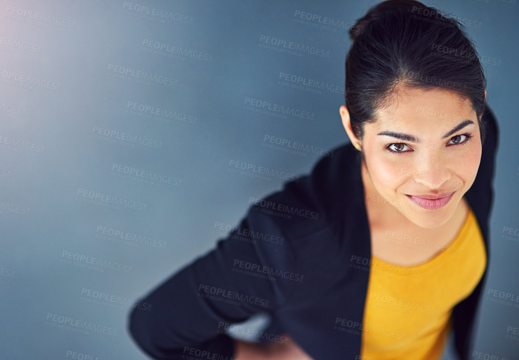 Buy stock photo Studio, lawyer and portrait of woman, confident and professional with top view, legal and mockup. Blue background, student and smile of person, internship and career in law firm for financial advisor