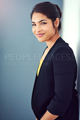 Buy stock photo Studio portrait of an attractive young businesswoman standing against a blue background