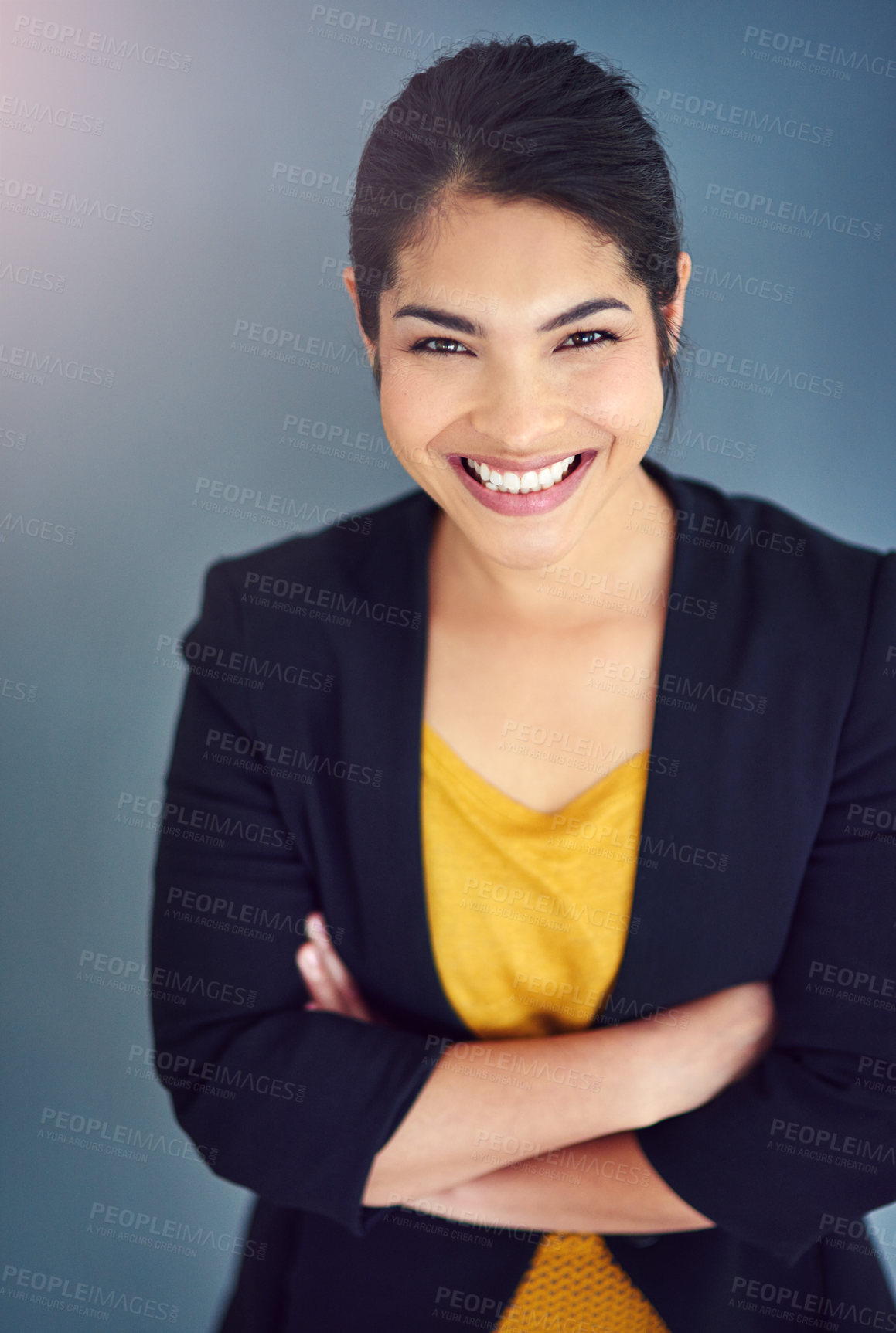 Buy stock photo Studio portrait of an attractive young businesswoman standing against a blue background
