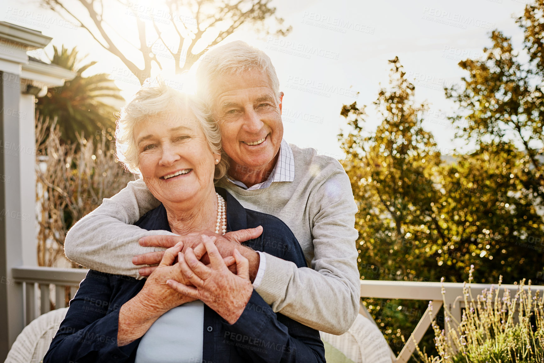 Buy stock photo Hug, patio and portrait of senior couple at sunrise enjoy bonding, quality time and relax in morning. Love, retirement home and face of elderly man and woman smile for marriage, trust and happiness