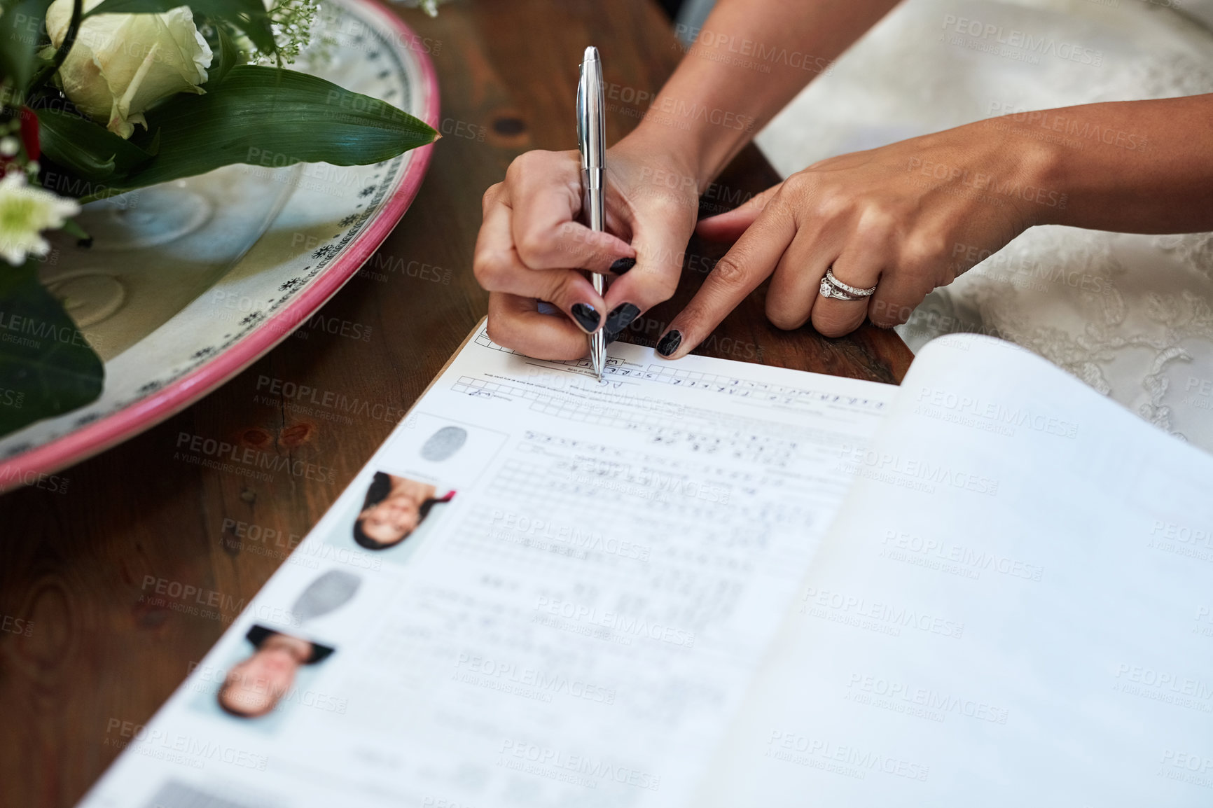 Buy stock photo Cropped shot of an unrecognisable bride signing paperwork on her wedding day
