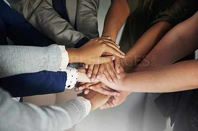 Buy stock photo Closeup shot of a group of unrecognisable businesspeople joining their hands together in unity