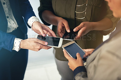 Buy stock photo Cropped shot of a group of unrecognisable businesspeople using their cellphones together in an office