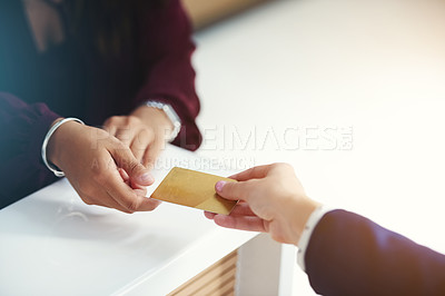 Buy stock photo Cropped shot of an unrecognisable person handing over a credit card for payment