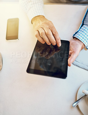 Buy stock photo High angle shot of an unrecognizable senior man using a tablet in a coffee shop