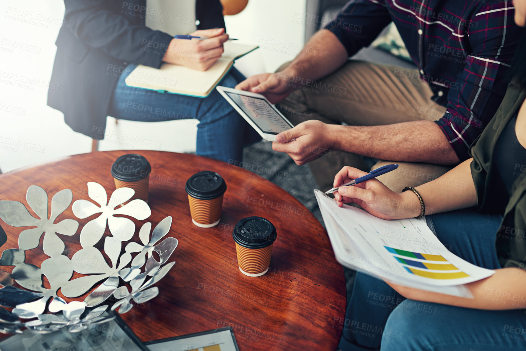 Buy stock photo Cropped shot of a group of colleagues having a meeting in a modern office