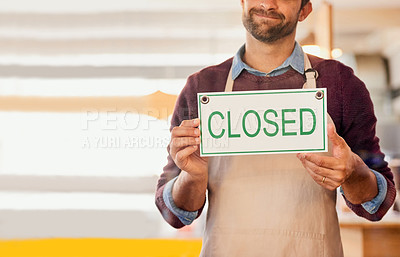 Buy stock photo Shot of an unidentifiable business owner holding up a closed sign in the window of his coffee shop