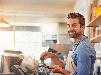 Buy stock photo Portrait of a happy business owner preparing coffee behind the counter in his coffee shop