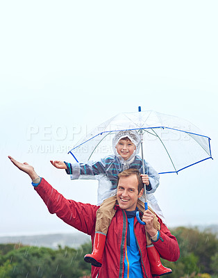 Buy stock photo Rain, umbrella and father with child for family portrait outdoor for fun, happiness and quality time. Man and boy kid in nature with hand to catch water drops for freedom, learning and play or mockup