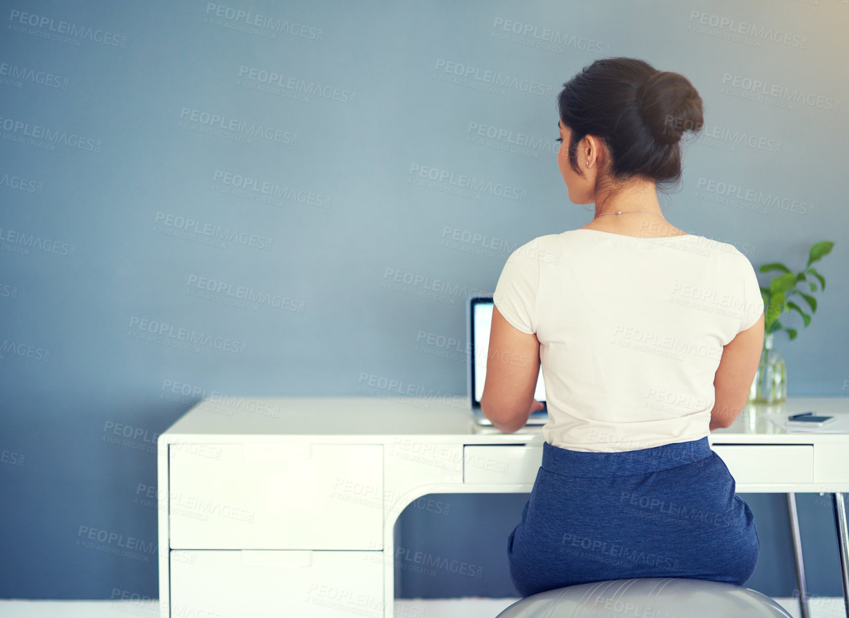 Buy stock photo Cropped shot of a young businesswoman working on her laptop at home