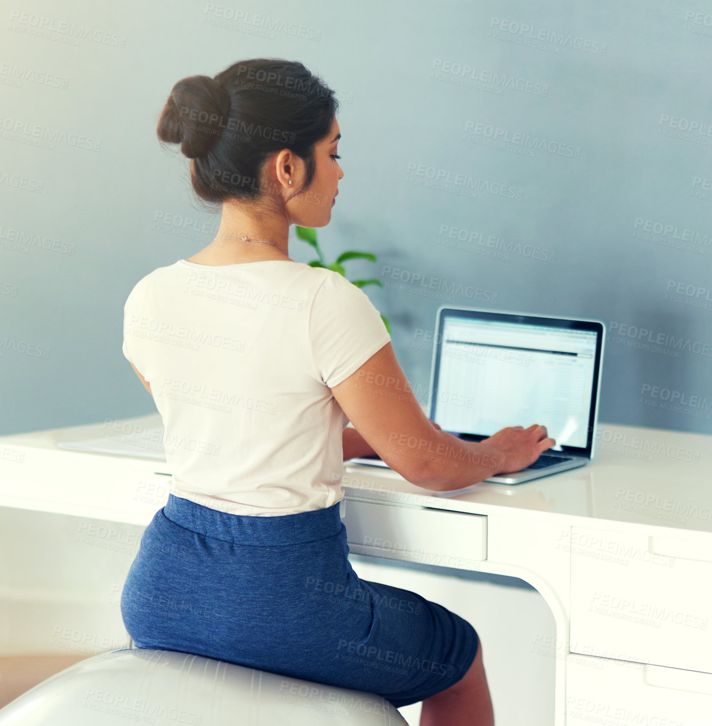 Buy stock photo Cropped shot of a young businesswoman working on her laptop at home