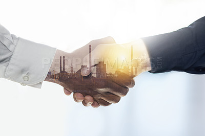 Buy stock photo Shot of a factory superimposed over two unidentifiable businessmen shaking hands in the office