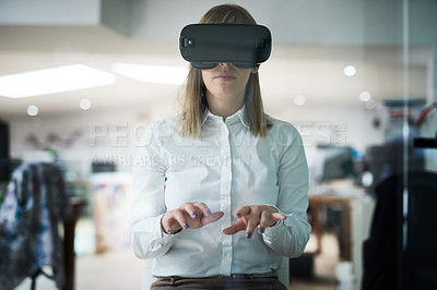 Buy stock photo Multiple exposure shot of a young businesswoman wearing a VR headset while working alone in her office